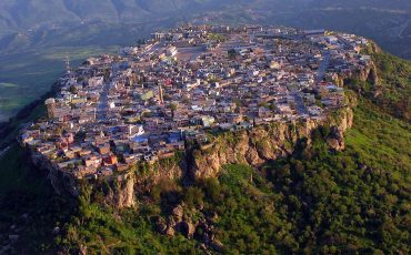 The picturesque village of Amedye, Iraq, sits on a mountain top between the desert and the fertile lands of Northern Iraq. Soldiers from Command Post-North, Task Force Lightning, flew over the village after taking part in Kurdish Labour Day celebrations nearby, May 1.
